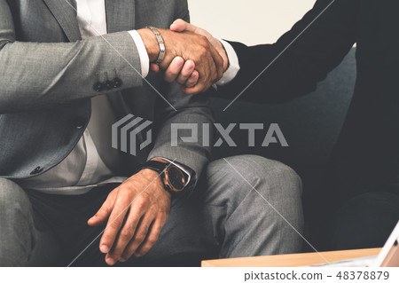 Businessmen handshake business deal in office. Businessmen handshake business deal in office. 48378879