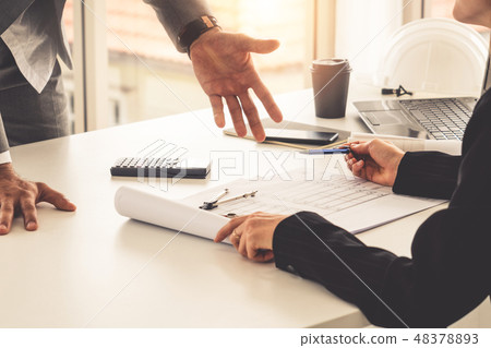 Architect and engineer working with drawing. Architect and engineer working with drawing. 48378893