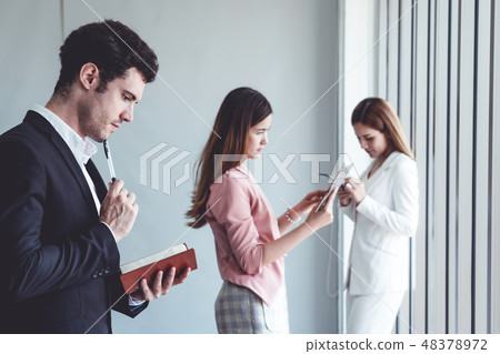 Businessman reading book in business office . 48378972