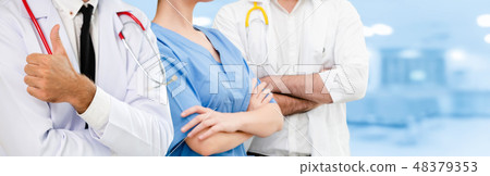 Doctor working in hospital with other doctors. 48379353