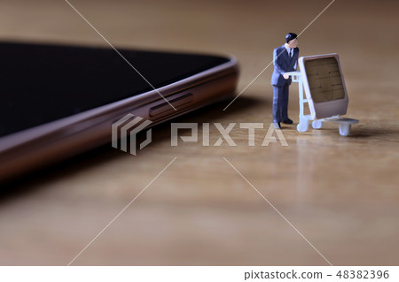 A man who pulls out a SIM card from a smart phone A man who pulls out a SIM card from a smart phone 48382396