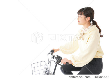 A young woman driving a bicycle 48383858