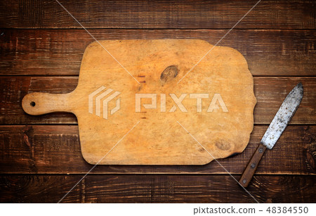 A wooden cutting board with a vintage rural knife A wooden cutting board with a vintage rural knife 48384550