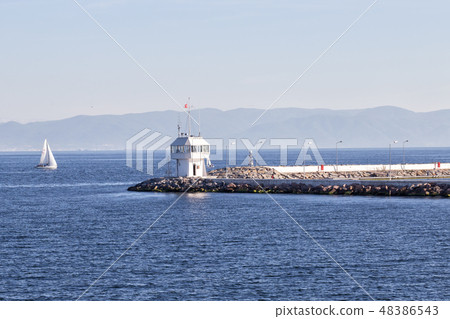 Pier with lighthouse and yacht in sea of Bosphorus Pier with lighthouse and yacht in sea of Bosphorus 48386543