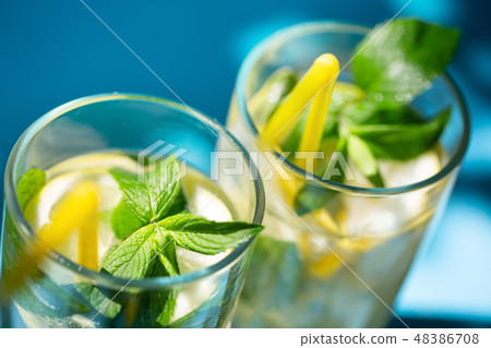 Fragments of glasses of homemade lemonade with mint Fragments of glasses of homemade lemonade with mint 48386708