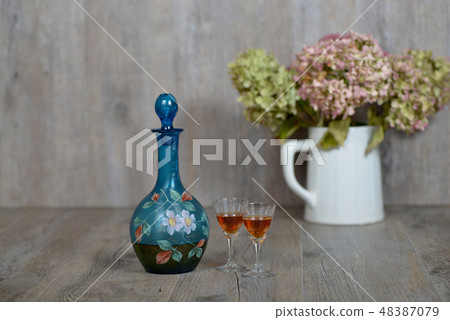 Former decanter with two glasses with liqueur Former decanter with two glasses with liqueur 48387079