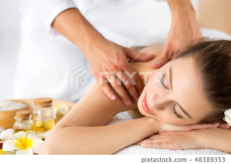 Beautiful young woman laying at spa salon 48389353