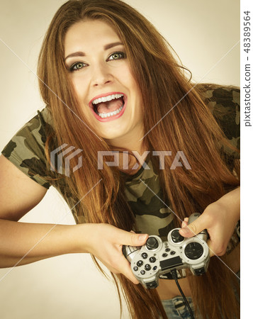 Gamer woman holding gaming pad Gamer woman holding gaming pad 48389564