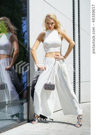 Woman wearing crop top and culottes Woman wearing crop top and culottes 48389657