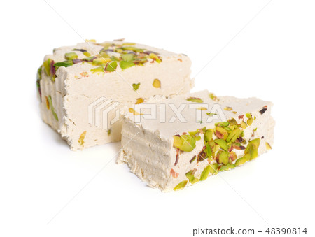 Tahini-based halva with pistachios. Isolated Tahini-based halva with pistachios. Isolated 48390814
