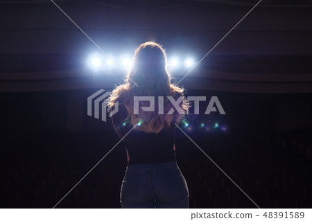 unrecognizable singer standing on stage at microphone in night club unrecognizable singer standing on stage at microphone in night club 48391589