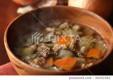 Consomme soup of steamy beef and vegetables 48391982