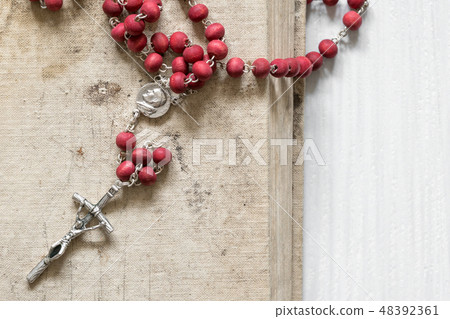 Christian cross  on the old book 48392361