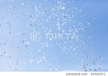 Water drops in the air against the sky 48392421