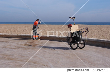 City workers - cleaning and washing of city street City workers - cleaning and washing of city street 48392452