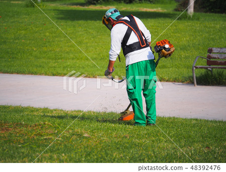 City workers - summer lawn mowing City workers - summer lawn mowing 48392476