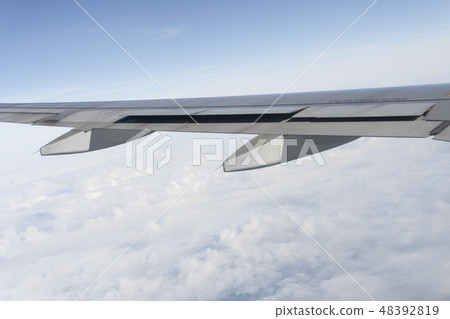 Plane wings are in the atmosphere 48392819