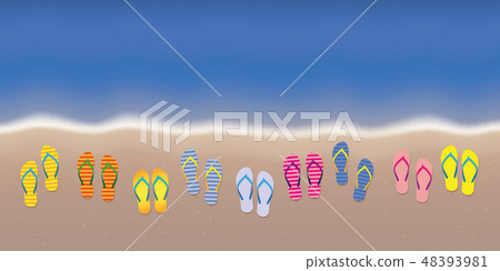 many flip flops on the beach with dark blue water 48393981