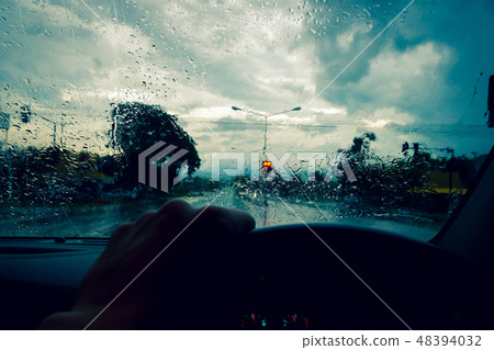 Drive on the road while heavy rain storms,Please be careful when driving in rainy road 48394032