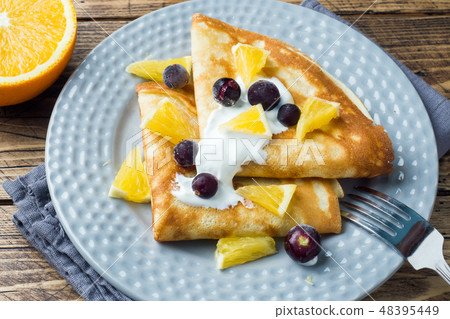 A portion of pancakes with berries and cream A portion of pancakes with berries and cream 48395449