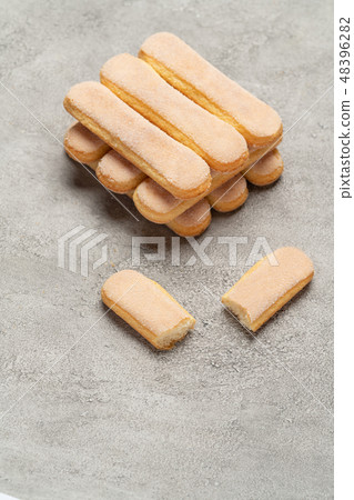Italian Savoiardi ladyfingers Biscuits on concrete backgound 48396282
