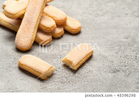 Italian Savoiardi ladyfingers Biscuits on concrete backgound Italian Savoiardi ladyfingers Biscuits on concrete backgound 48396298
