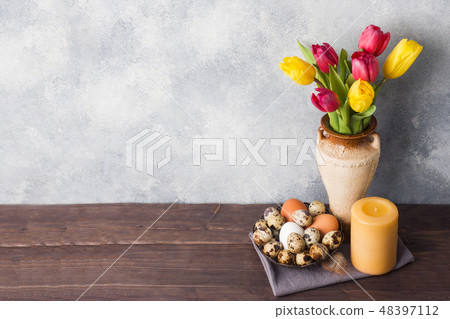 Concept Easter, tulips in a vase and a basket  48397112