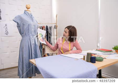 Designer concept. The dressmaker is designing an evening dress i 48397209