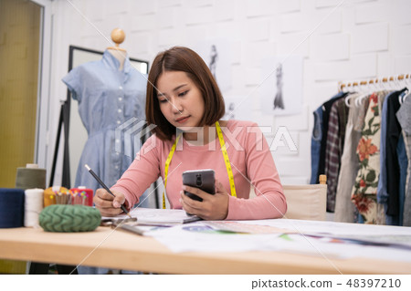 Designer concept. The dressmaker is designing an evening dress i 48397210