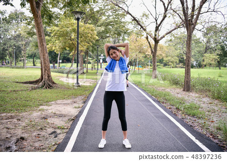 Exercise concept. beautiful girl is exercising in the park. Beau Exercise concept. beautiful girl is exercising in the park. Beau 48397236