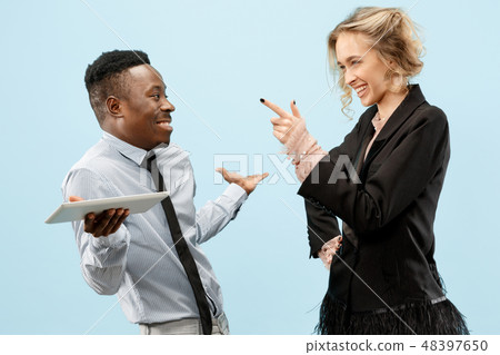 Concept of partnership in business. Young man and woman standing at studio 48397650