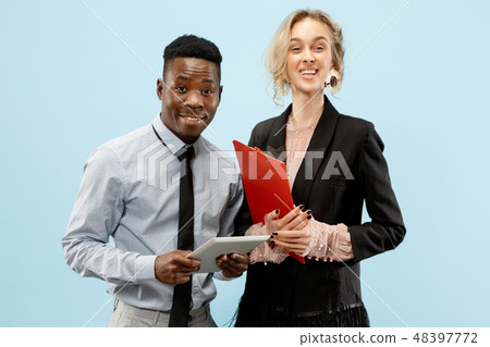 Concept of partnership in business. Young man and woman standing at studio 48397772
