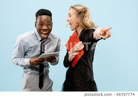 Concept of partnership in business. Young man and woman standing at studio 48397774