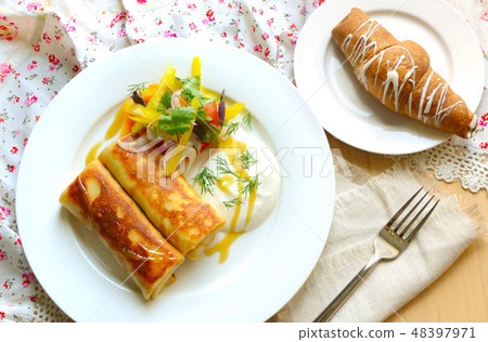 Breakfast with meat rolls and vegetable salad. 48397971