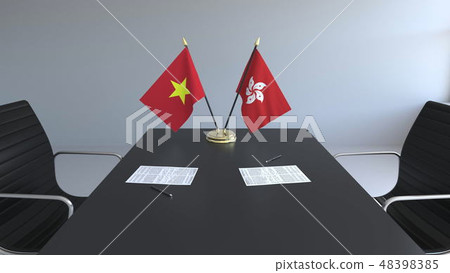 Flags of Vietnam and Hong Kong and papers on the table. Negotiations and signing an international 48398385