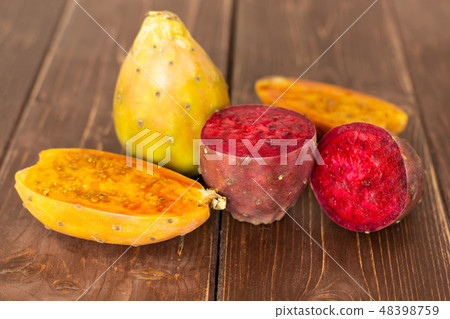 Fresh bright prickly pear opuntia on brown wood Fresh bright prickly pear opuntia on brown wood 48398759
