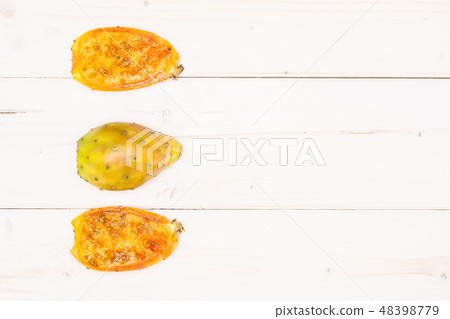 Fresh bright prickly pear opuntia on grey wood Fresh bright prickly pear opuntia on grey wood 48398779