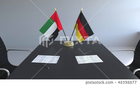 Flags of the United Arab Emirates and Germany and papers on the table. Negotiations and signing an 48398877