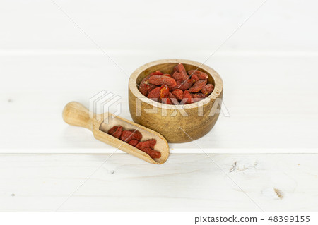Dried red goji berries on grey wood Dried red goji berries on grey wood 48399155