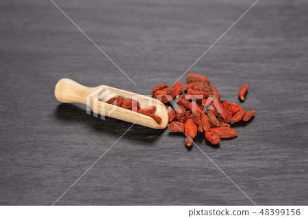 Dried red goji berries on grey stone 48399156