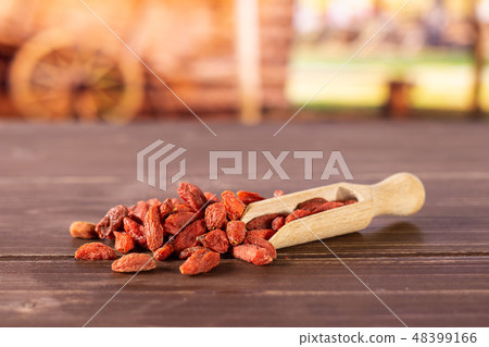 Dried red goji berries with cart Dried red goji berries with cart 48399166