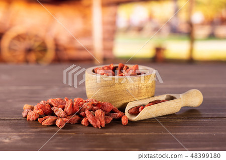 Dried red goji berries with cart Dried red goji berries with cart 48399180