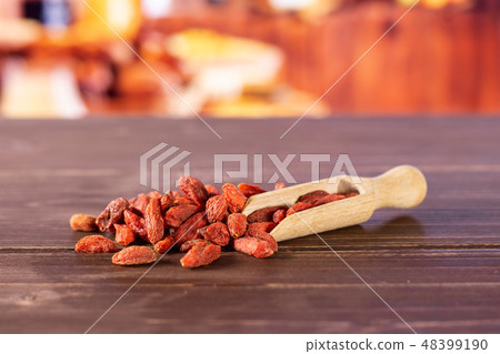Dried red goji berries with rustic kitchen Dried red goji berries with rustic kitchen 48399190