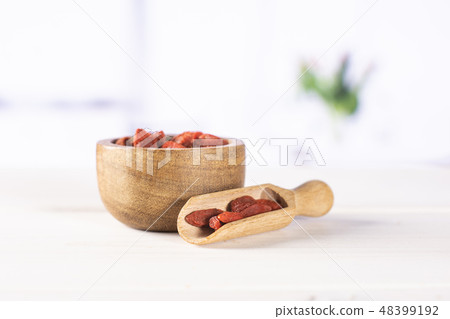 Dried red goji berries with red tulips Dried red goji berries with red tulips 48399192