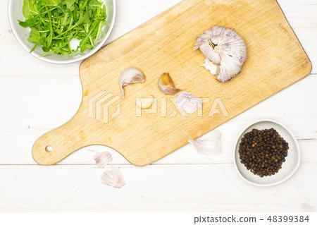 Recipe step farfalle with arugula on grey wood Recipe step farfalle with arugula on grey wood 48399384