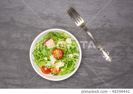 Recipe step by step arugula salad on grey stone Recipe step by step arugula salad on grey stone 48399442