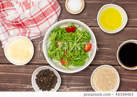 Recipe step by step arugula salad on brown wood Recipe step by step arugula salad on brown wood 48399465