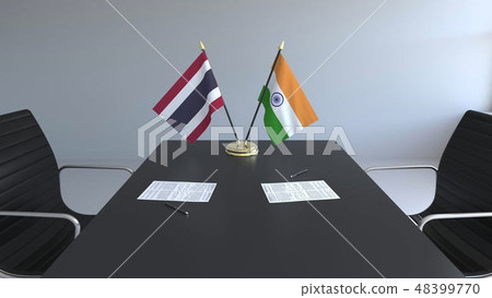 Flags of Thailand and India and papers on the table. Negotiations and signing an international 48399770