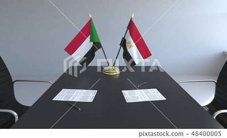 Flags of Sudan and Egypt and papers on the table. Negotiations and signing an international 48400005