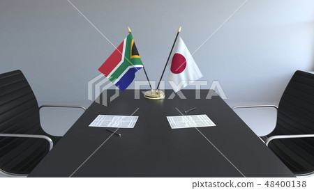 Flags of South Africa and Japan and papers on the table. Negotiations and signing an international 48400138